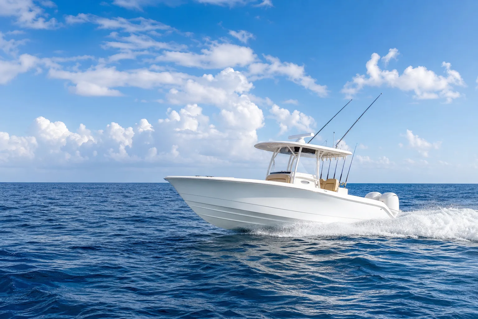 White center console fishing boat with T-top and fishing rods speeding across open blue ocean under a partly cloudy sky.
